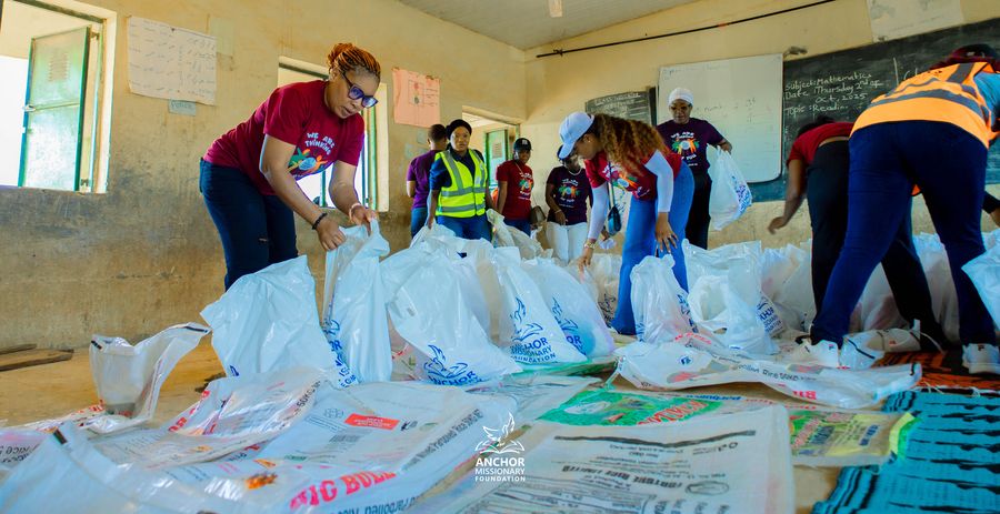 Volunteers arranging bags of rice ahead of a community distribution