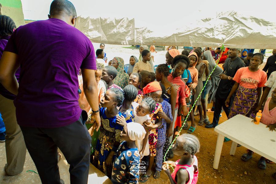 Children queue at an Anchor Missionary Foundation community outreach event